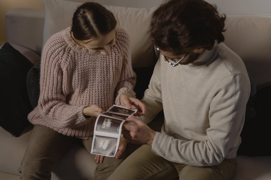 Seamless kaleidoscope wallpaper pattern — Medicine by wallpaper⁶ — base photo: A couple sits indoors, joyfully examining ultrasound images, celebrating an upcoming addition to the