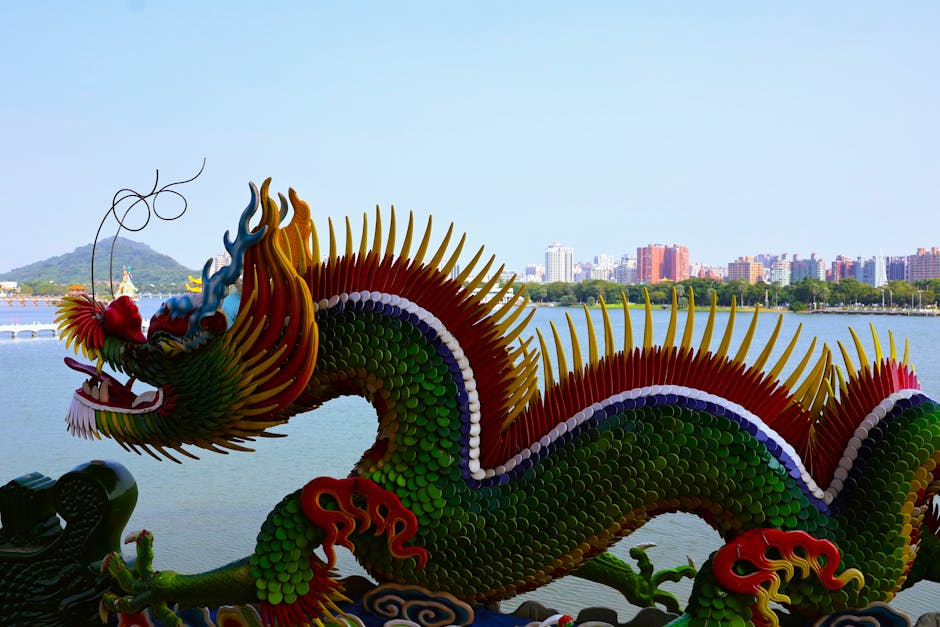 Seamless kaleidoscope wallpaper pattern — Origami by wallpaper⁶ — base photo: Colorful dragon sculpture by a serene lake in Taiwan, with city skyline in the background.