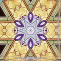 Colorful geometric kaleidoscope pattern inspired by Islamic stained glass, featuring vibrant reds, blues, and greens. Seamless repeat design.