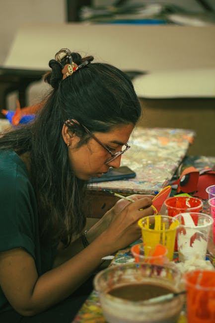 Seamless kaleidoscope wallpaper pattern — Origami by wallpaper⁶ — base photo: A dedicated art student engrossed in a painting project at Dhaka's Fine Art Faculty.