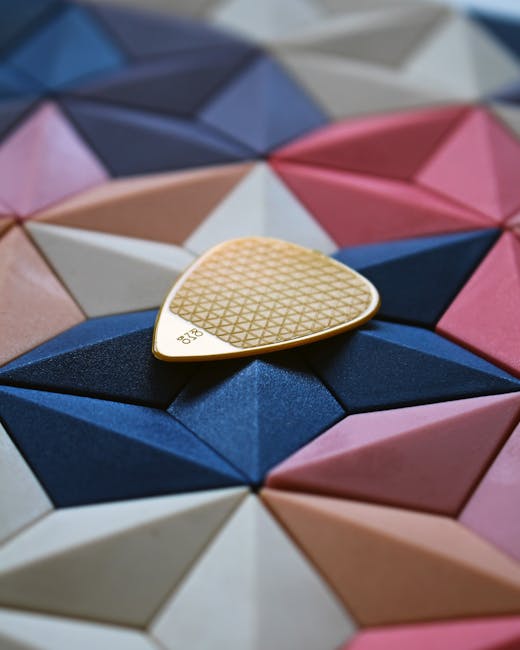 Seamless diamond wallpaper pattern — Origami by wallpaper⁶ — base photo: Colorful geometric pattern with a textured guitar pick on top.