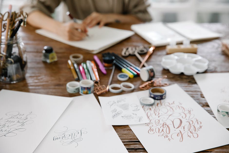 Seamless mirror wallpaper pattern — Calligraphy by wallpaper⁶ — base photo: A creative writing setup with various art supplies and calligraphy on papers.