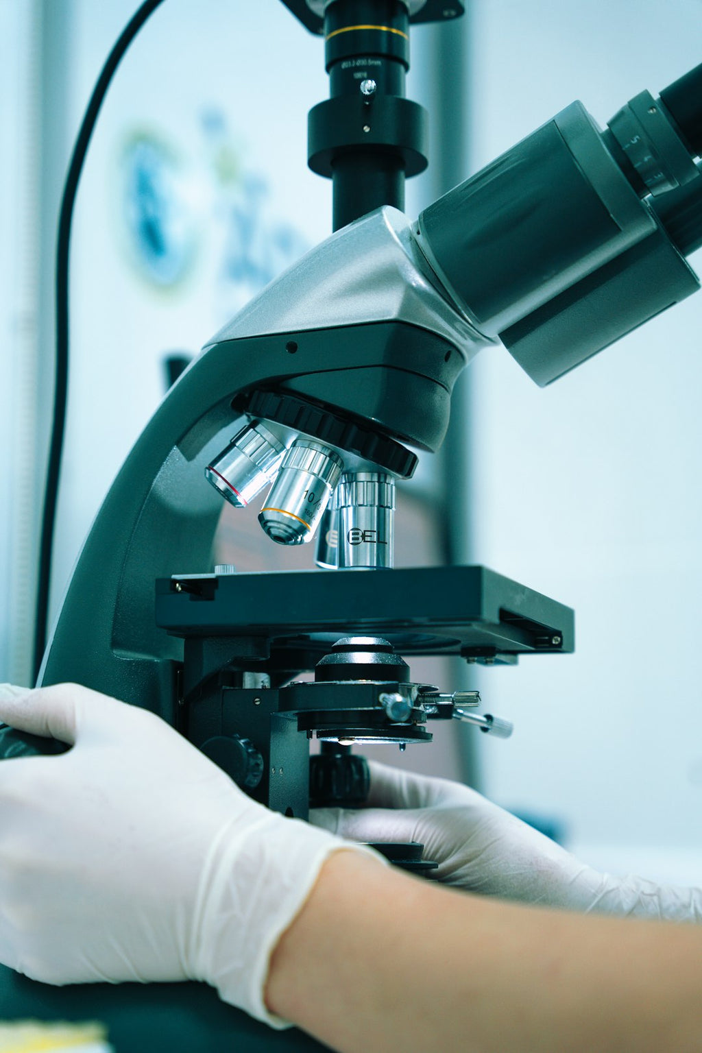 Seamless mirror wallpaper pattern — Medicine by wallpaper⁶ — base photo: a gloved hand operating a microscope in a laboratory