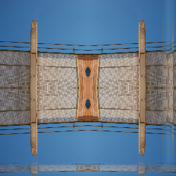 A mirrored geometric wallpaper pattern featuring red, blue, and yellow circles and lines on a cream background with Mirror symmetry.