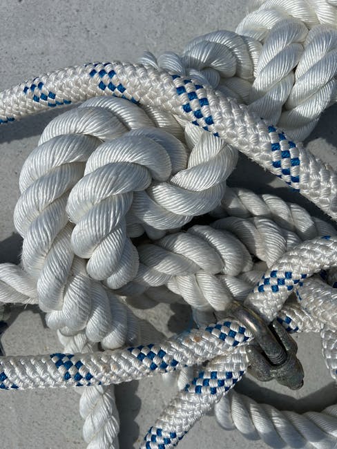Topology Kaleidoscope wallpaper pattern — base photo: A detailed photo of intertwined marine ropes with blue accents forming tight knots.