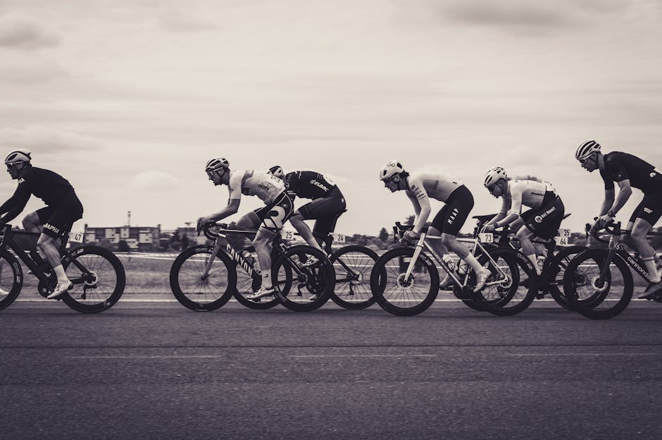 Seamless kaleidoscope wallpaper pattern — Biochemistry by wallpaper⁶ — base photo: Monochrome photograph of a fast-paced road cycling race with multiple cyclists in action.