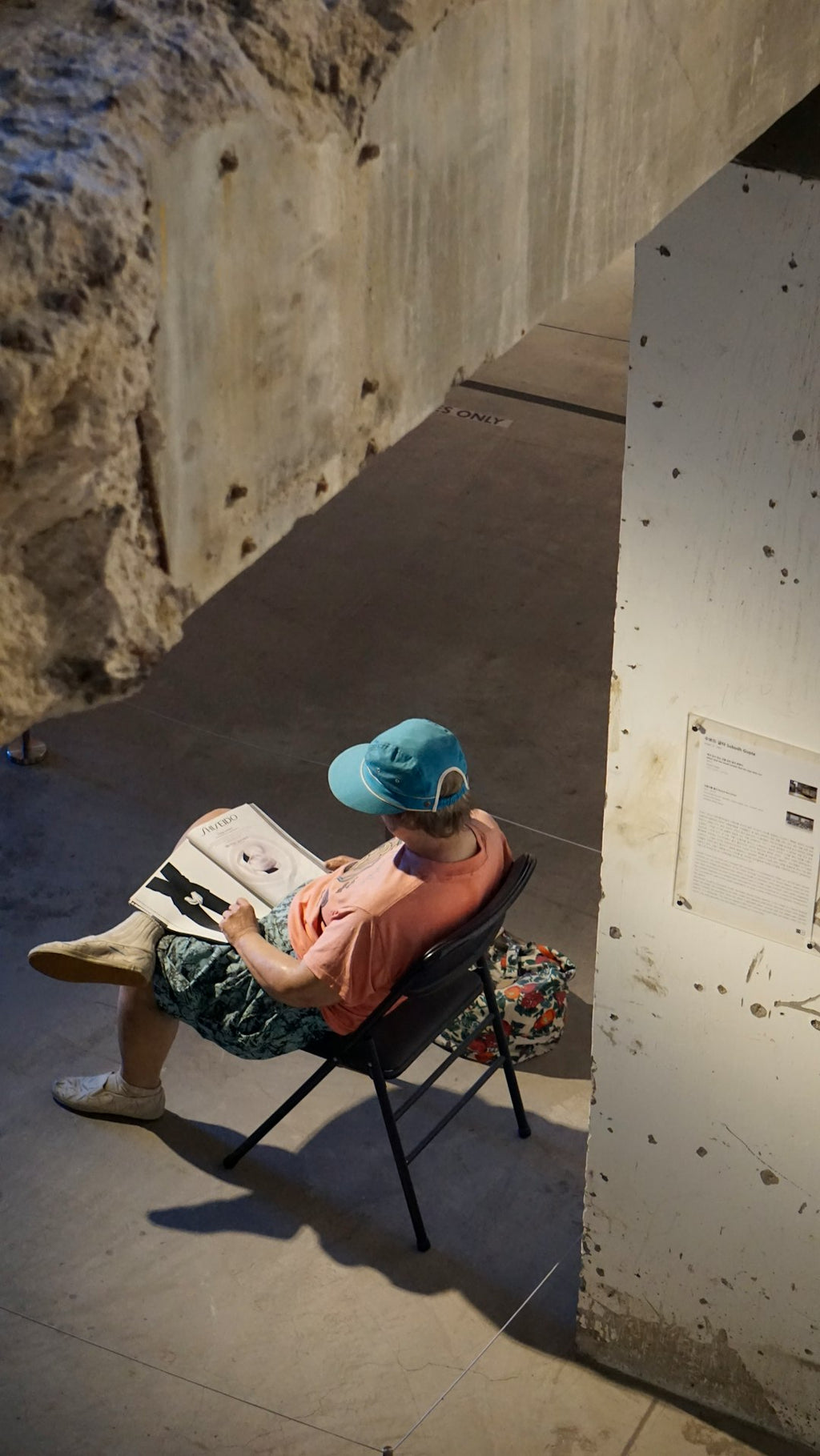 Seamless diamond wallpaper pattern — Origami by wallpaper⁶ — base photo: Person wearing a hat reads a book while sitting.