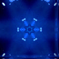 A vibrant kaleidoscope pattern made of jellyfish, with swirling blues, purples, and pinks, reminiscent of an underwater ocean scene.