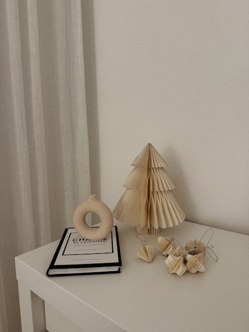 Seamless mirror wallpaper pattern — Origami by wallpaper⁶ — base photo: Simple and elegant Christmas decorations with a book and handmade ornaments on a white table.