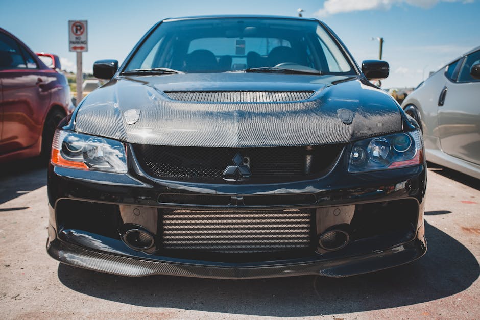 Molecular Physics Hexagon wallpaper pattern — base photo: Front view of a black Mitsubishi Lancer Evolution parked outdoors in daylight.