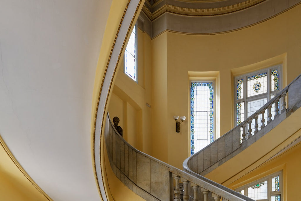 Seamless hex wallpaper pattern — Stained Glass by wallpaper⁶ — base photo: A monumental staircase traces gentle curves beneath a clear dome, bathed in light that enters throug