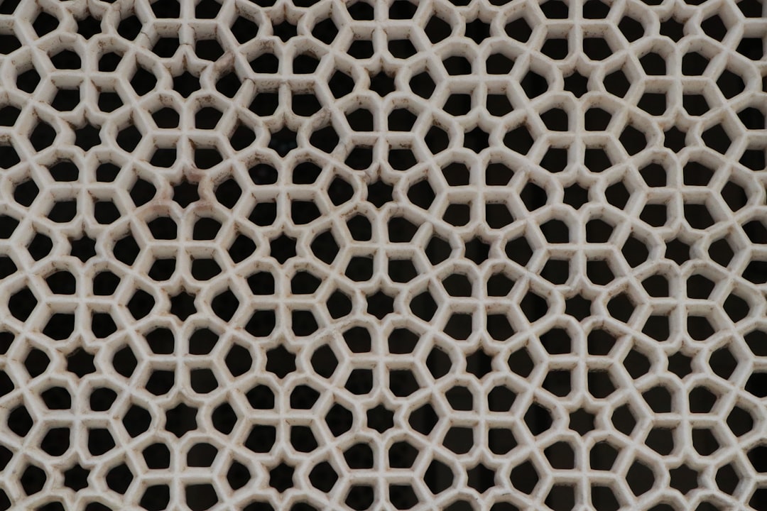 Borromean Rings pattern in kaleidoscope symmetry, a topology-themed design by Muskan Dev for wallpaper⁶. — base photo: A digital artwork depicting the abstract concept of Borromean rings, arranged with a captivating kal
