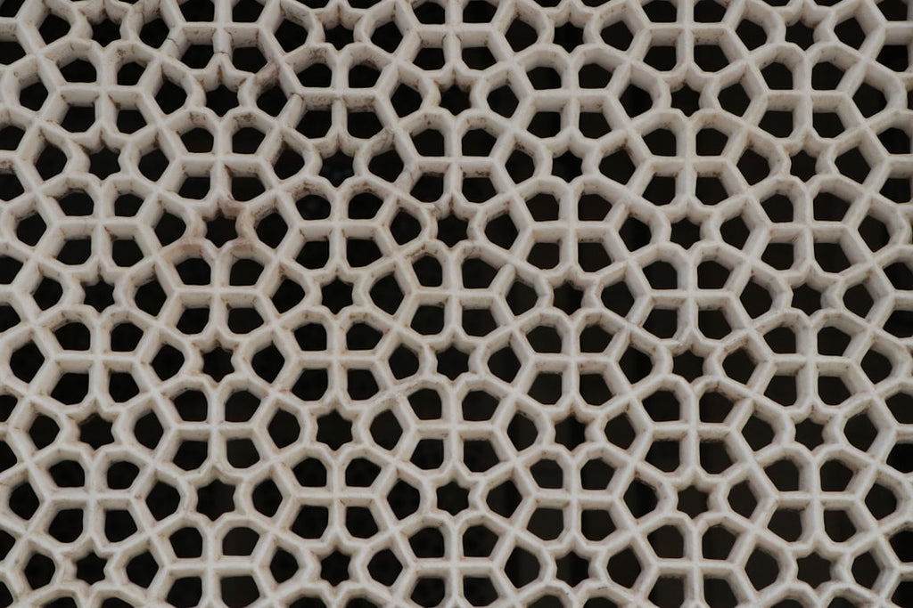 Intricate kaleidoscope pattern of Borromean Rings in topology, a seamless repeat design by Muskan Dev for wallpaper⁶. — base photo: A close-up of intertwined Borromean Rings, captured with sharp detail. The smooth, clean lines highl