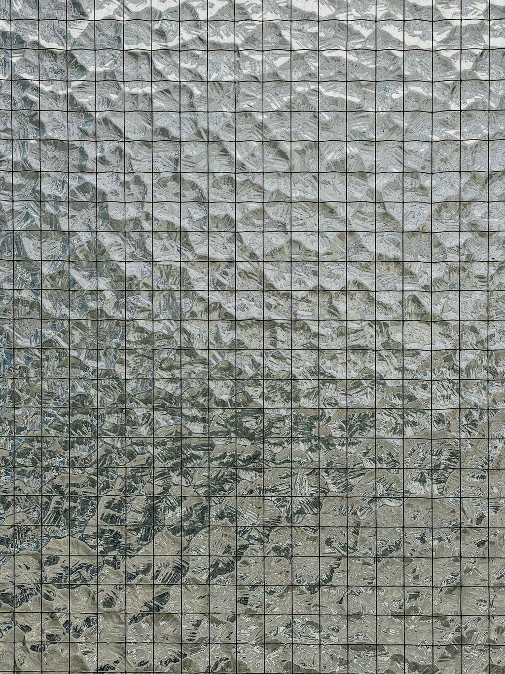 Seamless kaleidoscope wallpaper pattern — Stained Glass by wallpaper⁶ — base photo: This image displays a close-up of a glass building facade with a distinctive textured pattern. The g