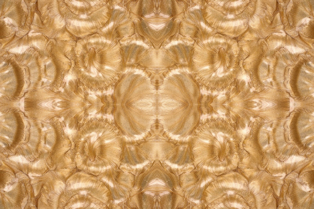 Close-up of a shimmering gold lattice wallpaper with diamond symmetry, showcasing an AI-generated geometric pattern. — base photo: A close-up macro shot of a metallic gold wallpaper displaying an intricate, repeating geometric latt
