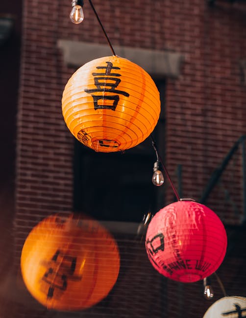 Seamless diamond wallpaper pattern — Origami by wallpaper⁶ — base photo: Vibrant orange and red lanterns with Chinese characters, hanging against a brick wall.