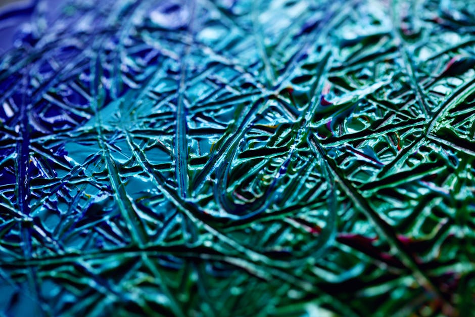 Close-up of a geometric abstract mosaic stained glass pattern with a wax texture in vibrant colors, repeating seamlessly. — base photo: A close-up view of colorful abstract patterns with an organic wax texture. The intricate details and