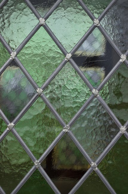 Green stained glass with a diamond pattern, arranged in a kaleidoscope, creating an abstract and artistic symmetrical repeat. — base photo: A close-up view of vibrant green stained glass. The intricate leaded details form a repeating diamon