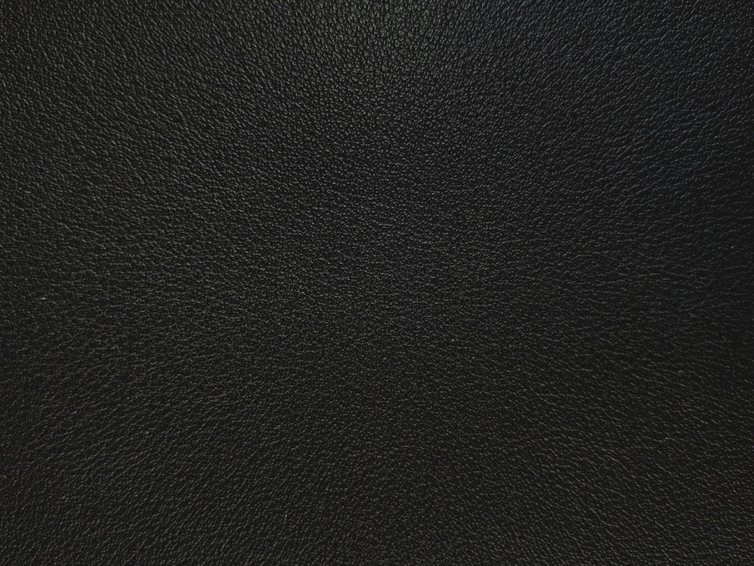 Seamless kaleidoscope wallpaper pattern — Cosmology by wallpaper⁶ — base photo: Close-up of textured black leather material