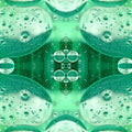 Abstract mirror pattern of green oil and water bubbles, resembling a scientific microscopic view, on wallpaper.