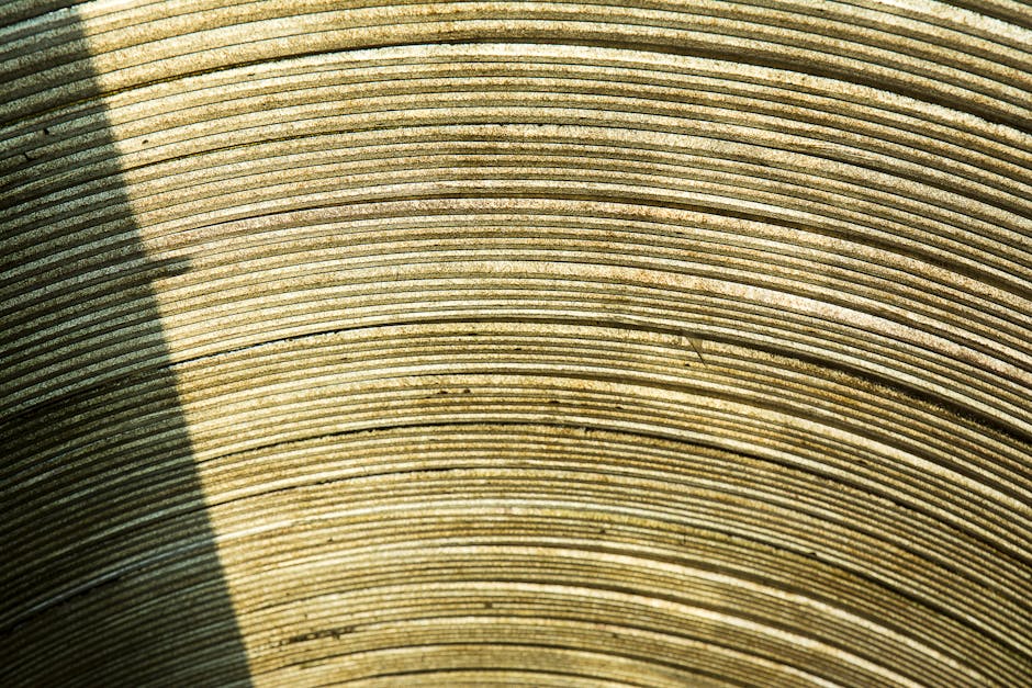 Seamless diamond wallpaper pattern — Origami by wallpaper⁶ — base photo: Detailed view of a textured stone surface with circular lines and shadows.