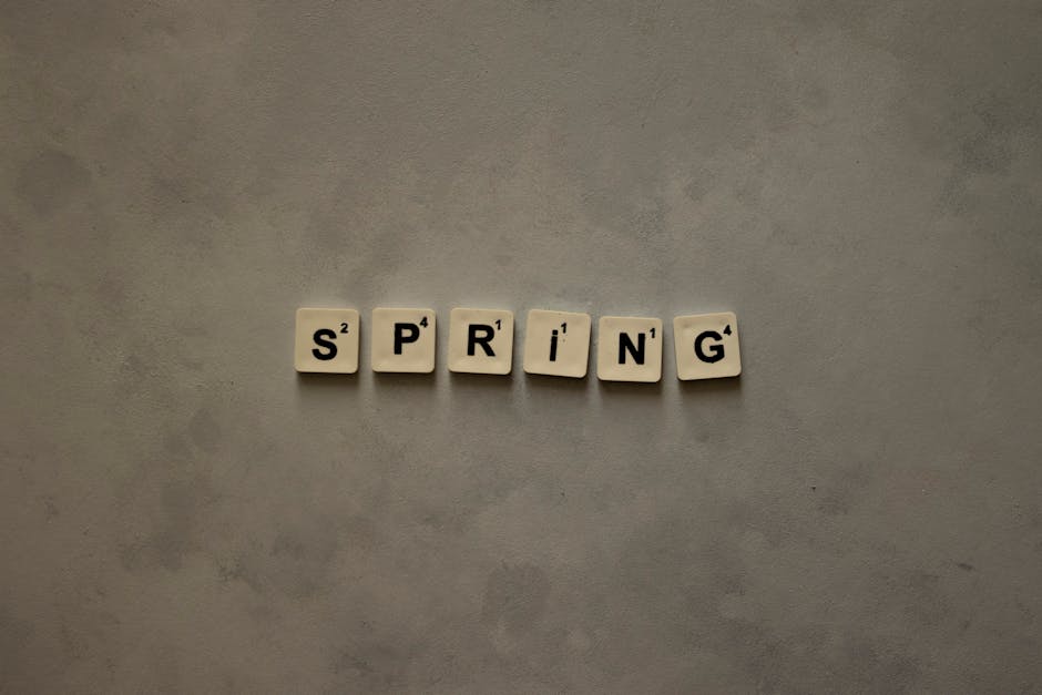 Seamless kaleidoscope wallpaper pattern — Calligraphy by wallpaper⁶ — base photo: Scrabble tiles on textured surface spelling 'Spring', ideal for seasonal themes.
