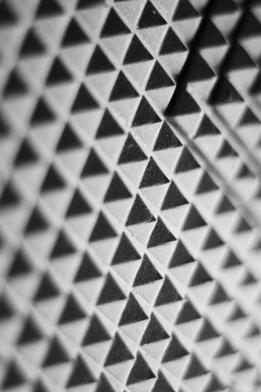 Black and white kaleidoscope pattern inspired by molecular physics and phonon dispersion on a wall. — base photo: A high-contrast black and white photograph of a wall, serving as the foundational texture for a comp