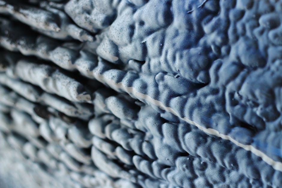 Op Art Kaleidoscope wallpaper pattern — base photo: Macro shot of a blue textured surface with wavy patterns creating a natural abstract design.