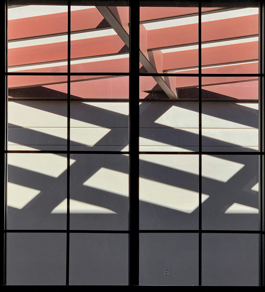 WALLPAPER⁶ — seamless mirror4 pattern from bauhaus geometric poster, Bauhaus — base photo: Geometric pattern through restaurant window