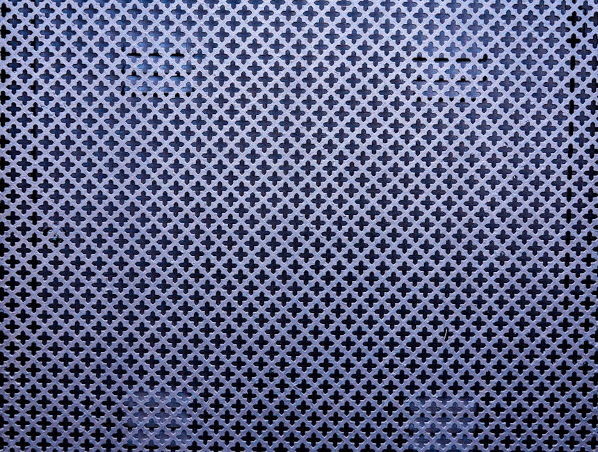 Seamless kaleidoscope wallpaper pattern — Geometry by wallpaper⁶ — base photo: Close-up of a metal wall with intricate patterns and shapes, creating a textured abstract design.