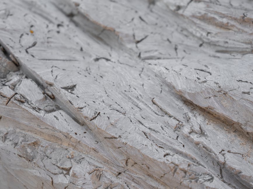 Mineralogy Hexagon wallpaper pattern — base photo: Detailed close-up of a rough gray stone with cracked texture and surface details.