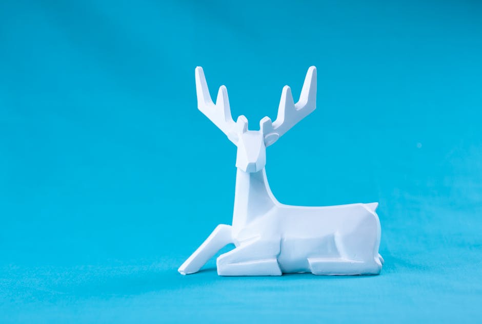 Seamless mirror wallpaper pattern — Origami by wallpaper⁶ — base photo: Minimalist style geometric deer statuette made of white plaster placed against vivid blue background