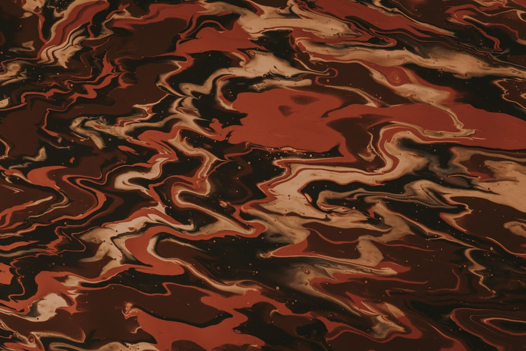 Close-up of abstract acrylic pour with swirling crimson, black, and white resembling marble, arranged in a diamond symmetry pattern. — base photo: A macro photograph captures the striking contrast and fluid movement of crimson, black, and white pi