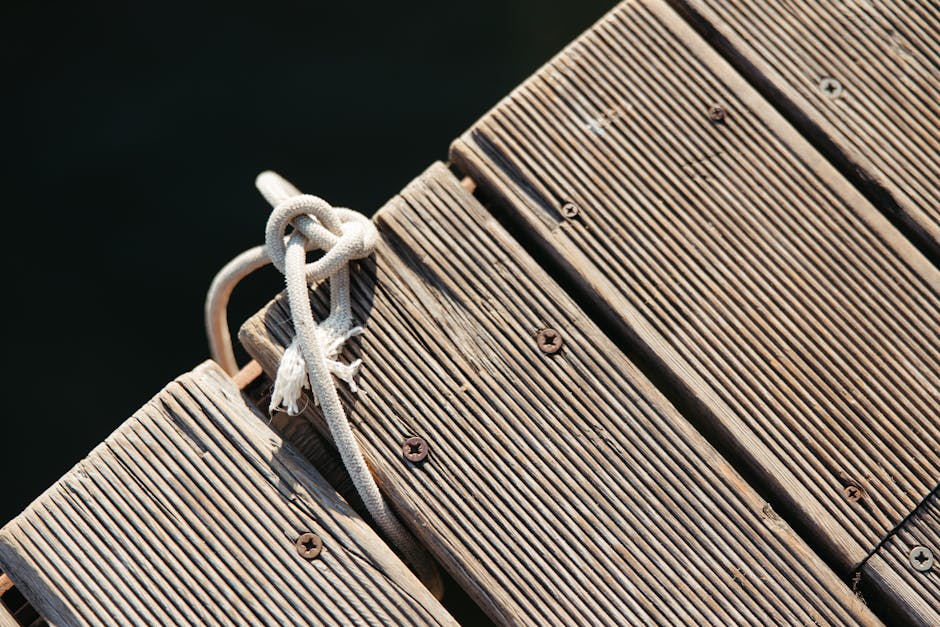 Topology Pinwheel wallpaper pattern — base photo: Detailed shot of a knotted rope on a textured wooden pier, perfect for nautical themes.