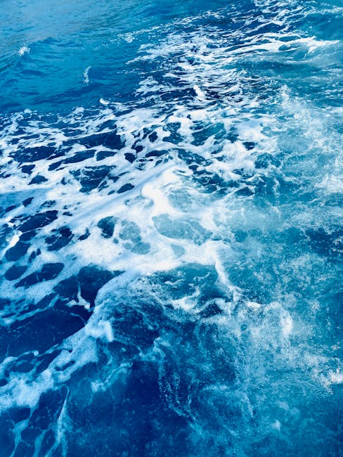 Oceanography Horizontal Strip wallpaper pattern — base photo: Dynamic waves flow in sparkling blue ocean water, creating a vivid, foamy texture.