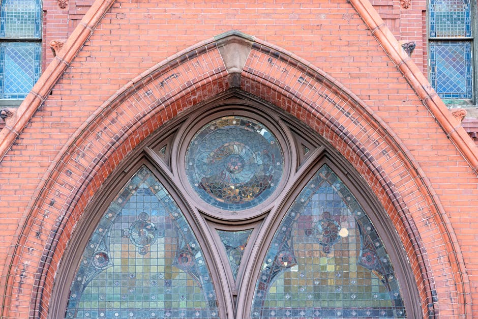 Close-up detail of stained glass window sections arranged in a repeating hexagonal pattern with dark leaded outlines. — base photo: A close-up captures the rich texture and subtle imperfections of leaded stained glass. The dark, thi