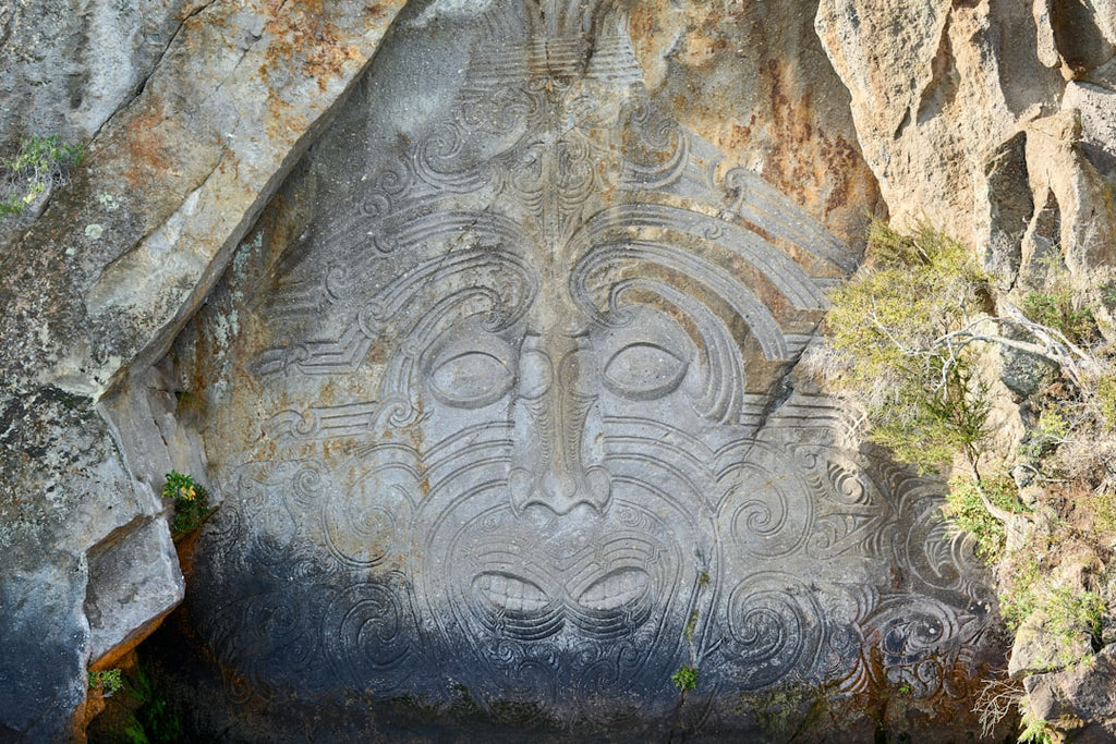Portraits Kaleidoscope wallpaper pattern — base photo: A maori carving is etched into a rock face.