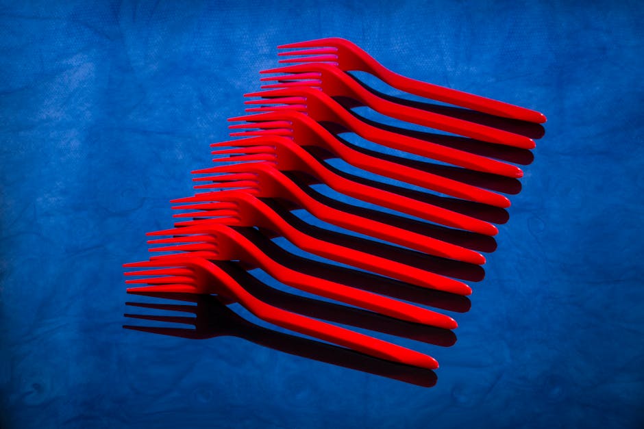 Seamless hex wallpaper pattern — Biochemistry by wallpaper⁶ — base photo: Artistic arrangement of red plastic forks on a vivid blue surface creating a striking visual contras