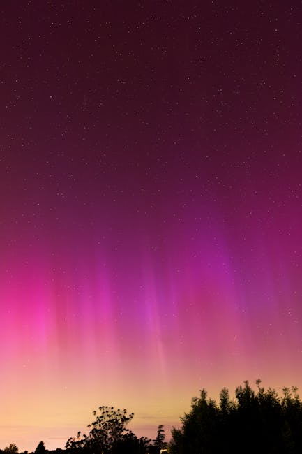 Seamless kaleidoscope wallpaper pattern — Astronomy by wallpaper⁶ — base photo: Vibrant aurora borealis with stars over Geneva's skyline, capturing nature's beauty at night.