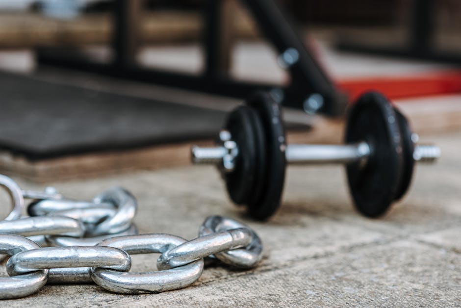 Seamless mirror wallpaper pattern — Biochemistry by wallpaper⁶ — base photo: Shiny heavy metallic chain near dumbbell with bar and plates on pavement in sunlight