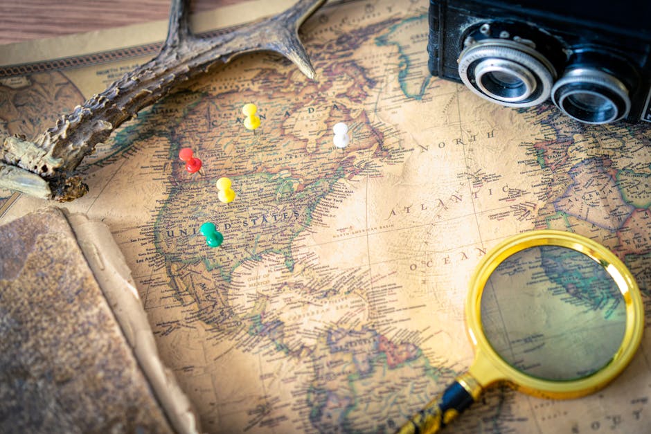 Seamless brick wallpaper pattern — Cartography by wallpaper⁶ — base photo: A vintage map with a magnifying glass, camera, and pushpins indicating travel planning.