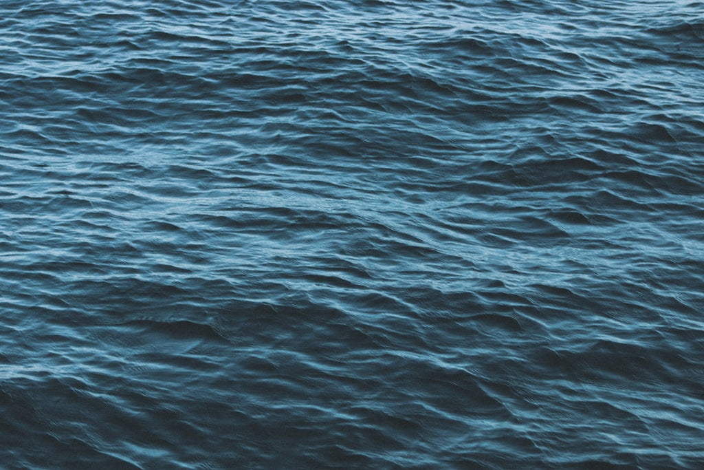 Oceanography Wave wallpaper pattern — base photo: a boat floating on top of a large body of water