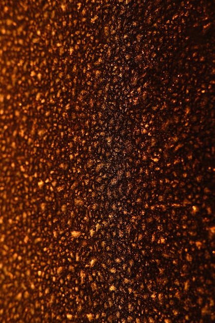 Seamless mirror wallpaper pattern — Cartography by wallpaper⁶ — base photo: A detailed close-up photo of a textured surface with warm, rich lighting creating an abstract patter