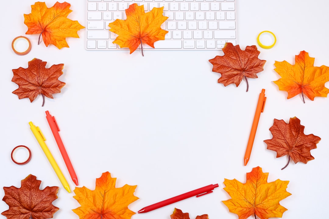 Botanics Hexagon wallpaper pattern — base photo: Orange, red, and brown autumn leaves in a beautiful flat lay with a keyboard and office supplies for