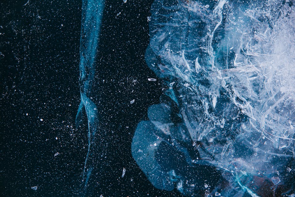 Mineralogy Brick wallpaper pattern — base photo: Captivating close-up of cracked ice creating an abstract texture on a dark background.