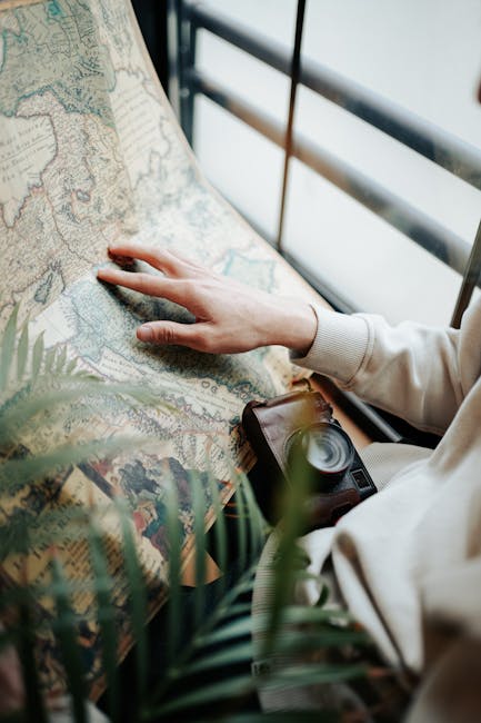 Seamless brick wallpaper pattern — Cartography by wallpaper⁶ — base photo: A close-up of hands exploring a vintage map indoors, highlighting adventure and exploration.