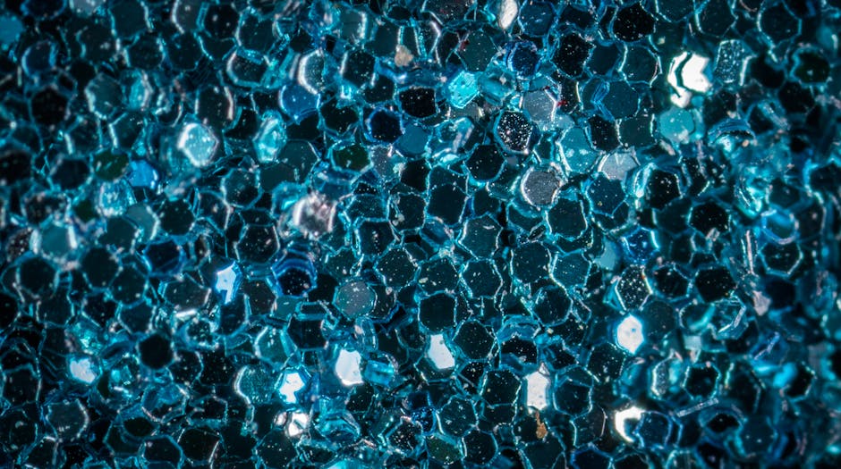 Seamless mirror wallpaper pattern — Geometry by wallpaper⁶ — base photo: Macro shot of sparkling blue glitter with hexagonal pattern, creating a vibrant abstract texture.