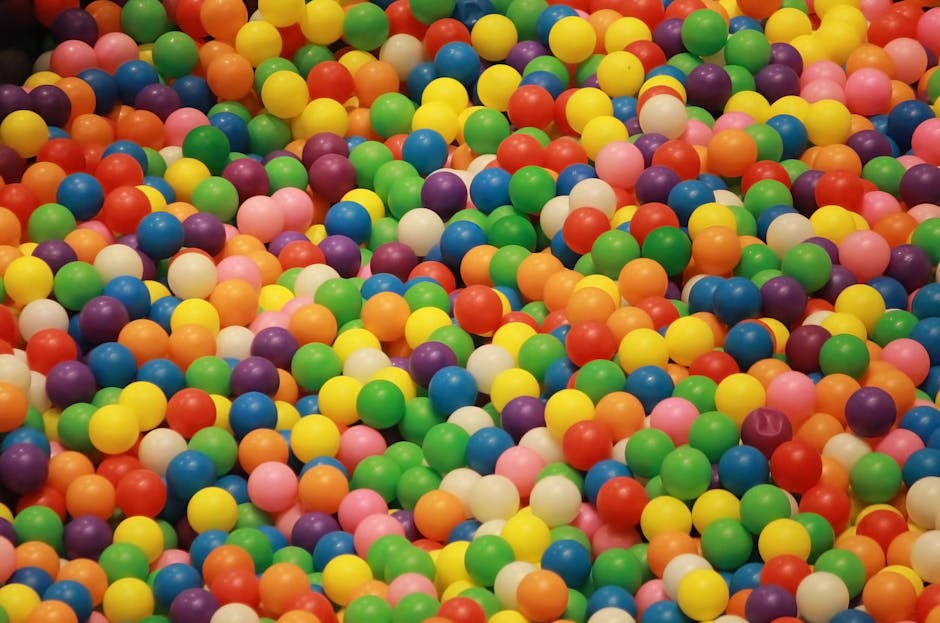 Seamless kaleidoscope wallpaper pattern — Arithmetic by wallpaper⁶ — base photo: A lively assortment of colorful plastic balls in a playful heap, perfect for creative or fun setting