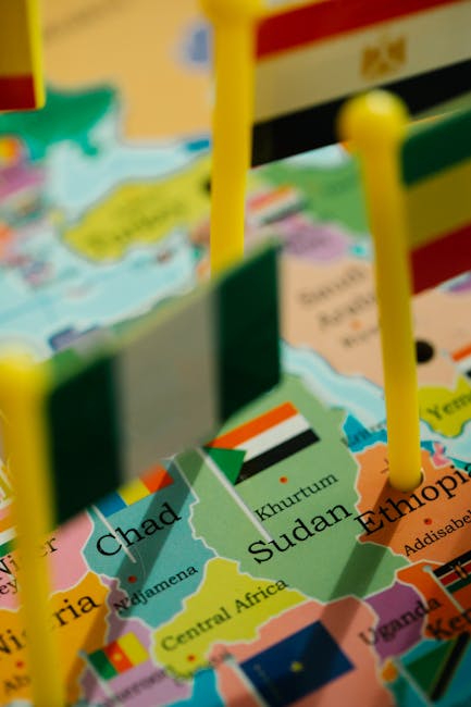 Seamless mirror wallpaper pattern — Cartography by wallpaper⁶ — base photo: Closeup of African political map featuring flags of various countries with selective focus