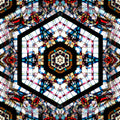A radial Kaleidoscope pattern of blue and amber stained glass fragments with leaded borders in a complex geometric repeat.